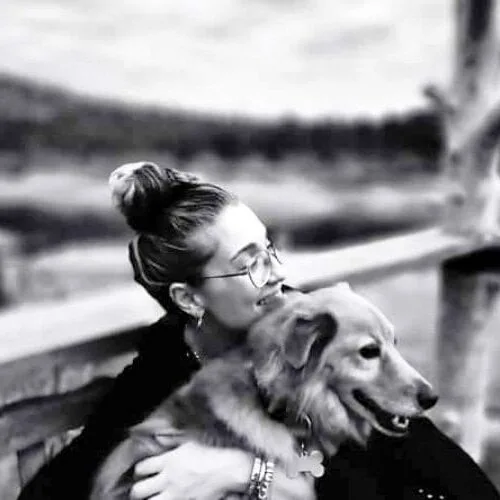 Danae, founder of Paws in Rhodes, hugging a dog